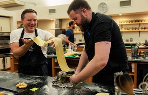 A tutor demonstrating knife skills and food preparation to a group of teenagers at Dublin Cookery School's Growing Gourmets teen cooking camp in Blackrock, Dublin