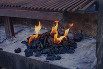 Charcoal fire lighting in a professional outdoor grill at Dublin Cookery School BBQ class