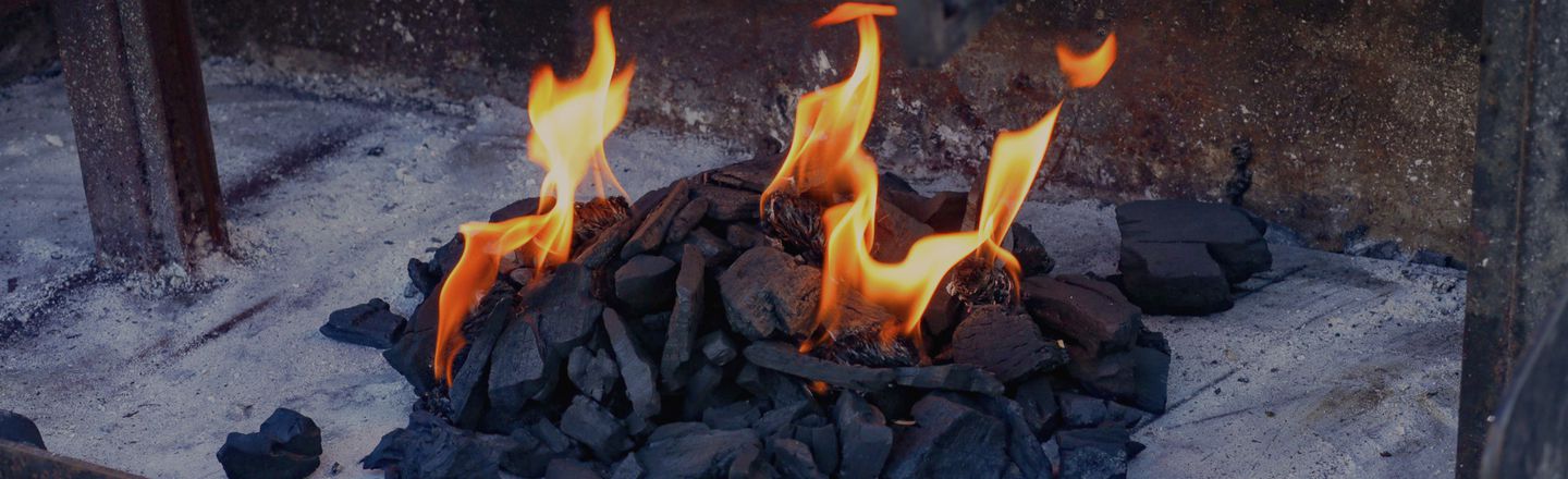 Charcoal fire burning in an Argentine-style grill — BBQ cooking class Dublin Cookery School