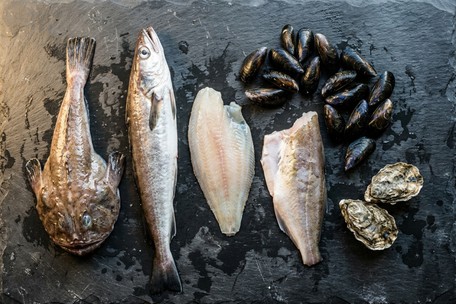 Fresh monkfish tail and Galway oysters on a wooden board — Dublin Cookery School spring seafood guide