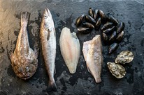 Fresh monkfish tail and Galway oysters on a wooden board — Dublin Cookery School spring seafood guide