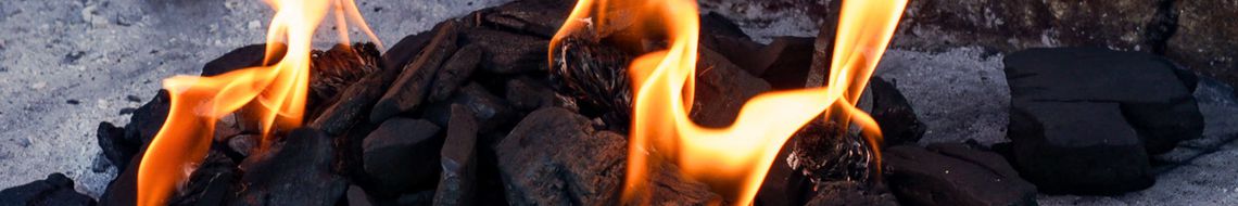 Close-up of charcoal flames in an outdoor grill — Dublin Cookery School BBQ cooking class Dublin