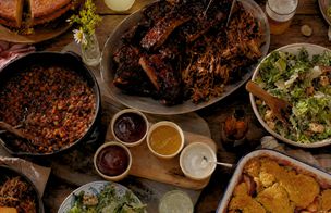 American BBQ spread with slow-cooked ribs, pulled pork, baked beans and cornbread — American BBQ class Dublin