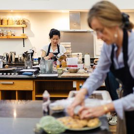 Two students working at their stations during a hands-on class at Dublin Cookery School in Blackrock, Dublin.