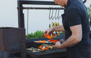 Chef Gerry grilling vegetables and oysters on an outdoor grill at Dublin Cookery School outdoor cooking class