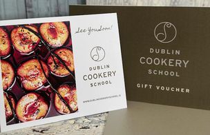 Homemade edible Christmas gifts displayed in the Dublin Cookery School kitchen — jars of chutney, biscuits, truffles, and mulled wine.