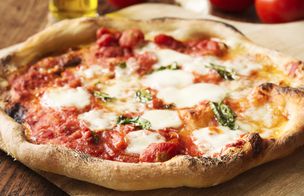 Naples Style pizza resting on a wooden board
