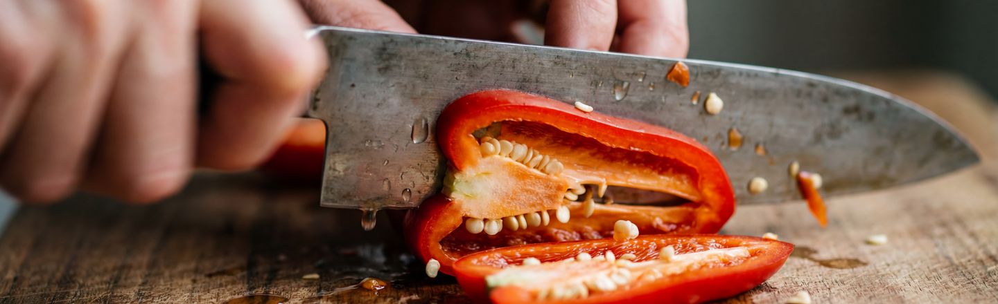 Close up of professional knife skills technique slicing red pepper at Dublin Cookery School.