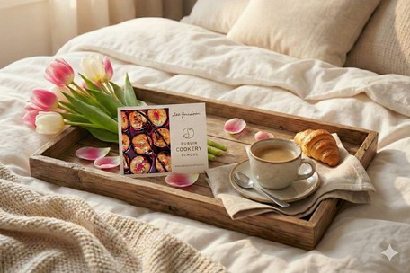 Dublin Cookery School Voucher displayed on a breakfast tray for a mum on mother's day with tulips, coffee and fresh pastry