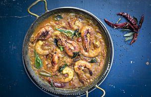 A top-down view of a homemade ramen bowl featuring soft-boiled eggs, sliced roast pork, and nori, demonstrating advanced healthy cooking techniques.