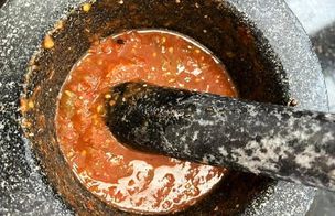 Pestle and mortar of a Mexican salsa rojo or red salsa
