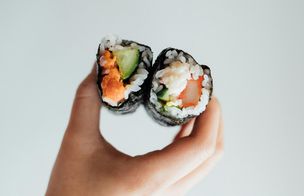 Overhead flat lay of sushi pizza, maki rolls, tonkatsu ramen, karaage chicken and Japanese sides on dark slate, Dublin Cookery School Growing Gourmets Japanese Fusion Feast two-day camp
