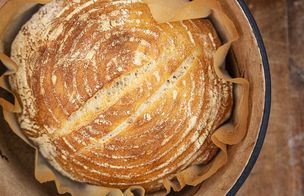 Perfectly golden sourdough cooling in dutch oven